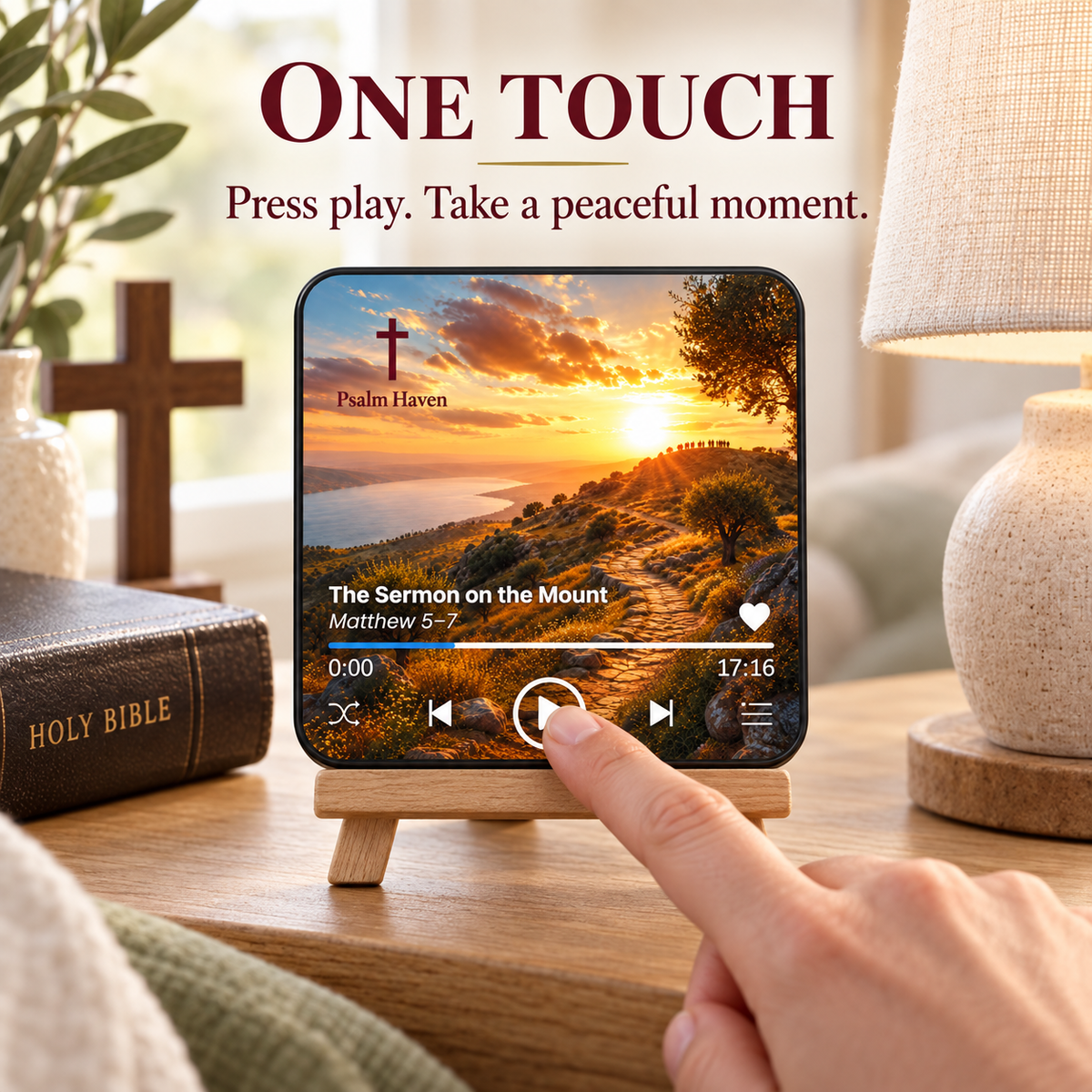 A finger pressing the play button on The Sermon on the Mount Audio Magnet
